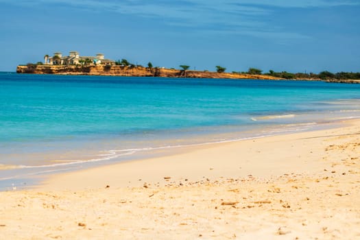 Caribbean beach with white sand, deep blue sky and turquoise water