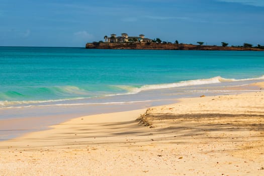 Caribbean beach with white sand, deep blue sky and turquoise water