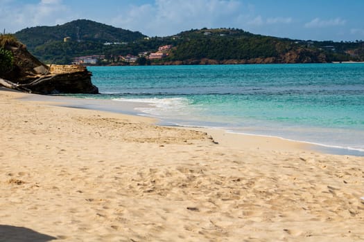 Caribbean beach with white sand, deep blue sky and turquoise water