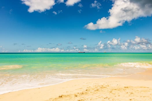 Caribbean beach with white sand, deep blue sky and turquoise water