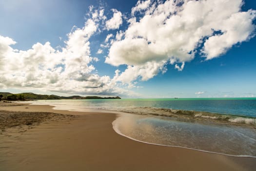 Caribbean beach with white sand, deep blue sky and turquoise water