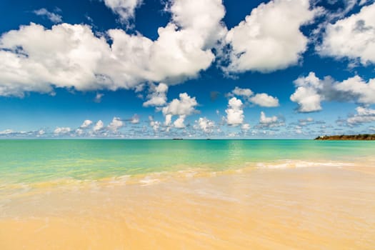 Caribbean beach with white sand, deep blue sky and turquoise water