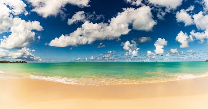 Caribbean beach with white sand, deep blue sky and turquoise water