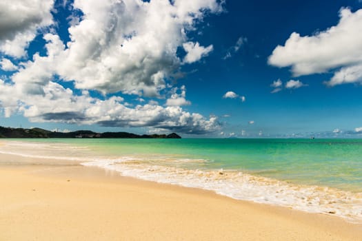 Caribbean beach with white sand, deep blue sky and turquoise water