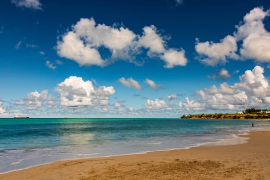 Caribbean beach with white sand, deep blue sky and turquoise water