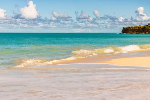 Caribbean beach with white sand, deep blue sky and turquoise water