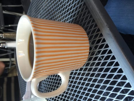 Striped Coffee Cup on a Patio Table at New York City Cafe. High quality photo