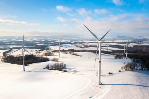Renewable energy wind turbines on the winter field. Green energy concept