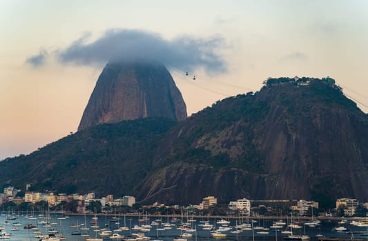 Twilight blankets Rio as cable cars climb Sugarloaf Mt.