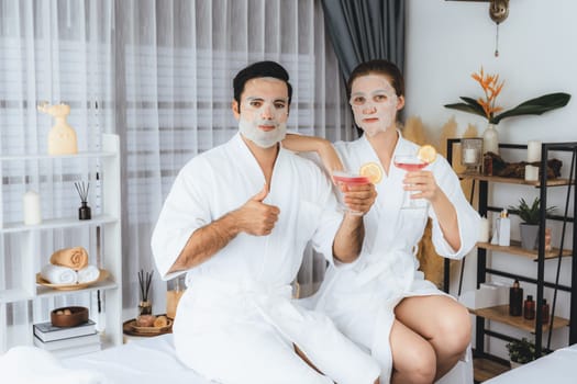 Serene modern daylight ambiance of spa salon, couple customer indulges in rejuvenating with facial skincare mask. Facial skin treatment and beauty cosmetology procedure for face. Quiescent