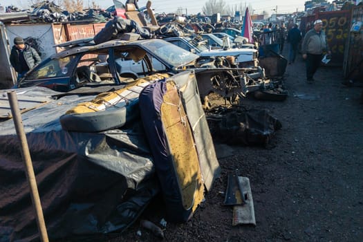 car parts at open air junkyard and used spare parts market in Kudaybergen, Bishkek, Kyrgyzstan - November 13, 2022