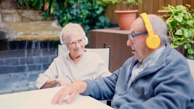 Photo of senior couple listening to music on the garden at home