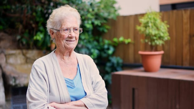 Photo of a distracted grandmother looking away outside a nursing home