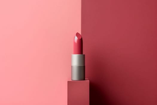 A single lipstick with matching pink background, poised elegantly.