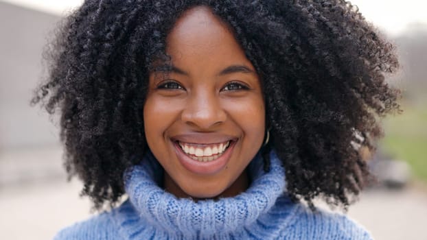 Beauty african young woman smiling at camera outdoors