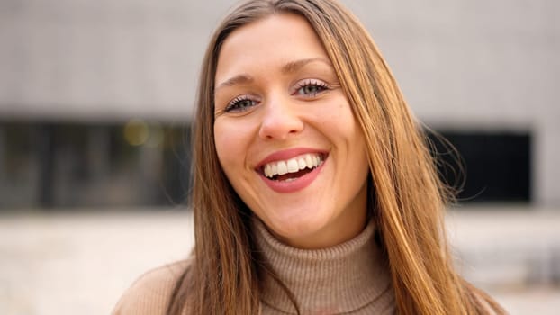 Caucasian and young female student laughing at camera outdoors