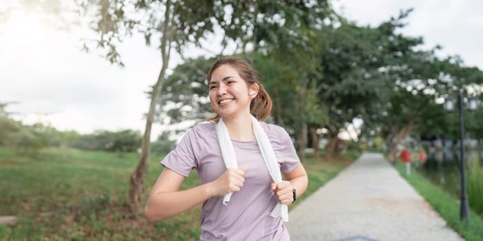 Women runner wearing sport cloths jogging in morning at park. Active morning.