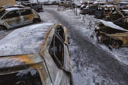 Kyiv, Ukraine - January 3, 2024: Burned civilians cars after a Russian's missiles attack.