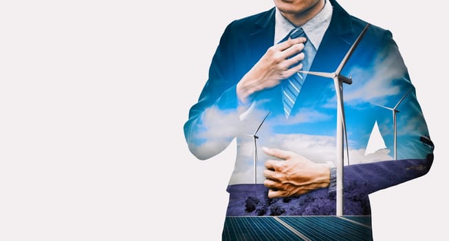 Double exposure graphic of business people working over wind turbine farm and green renewable energy worker interface. Concept of sustainability development by alternative energy. uds