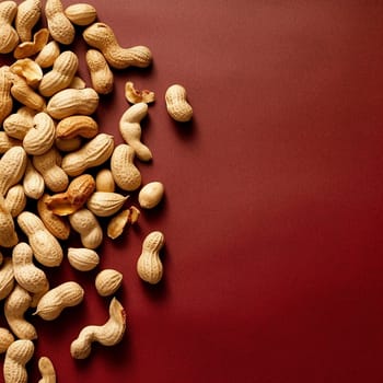 Assorted shelled peanuts on a red background.