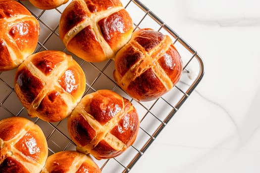 Traditional Easter hot cross buns on a cooling rack. AI generated.