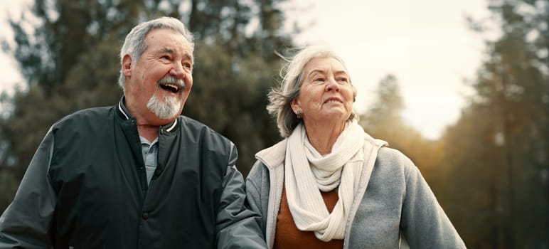 Love, smile and a senior couple walking outdoor in a park together for a romantic date during retirement. Happy, care or excited with an elderly man and woman bonding in a garden for romance.