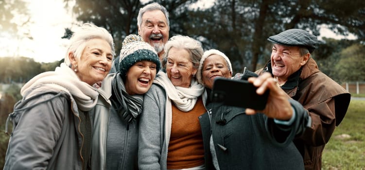 Excited, selfie and group of senior friends in outdoor green environment for fresh air. Diversity, happy and elderly people in retirement taking picture together while exploring and bonding in a park.