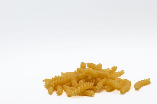 A vibrant yellow mound of fast food pasta beckons on a clean white canvas, promising a satisfying and indulgent experience