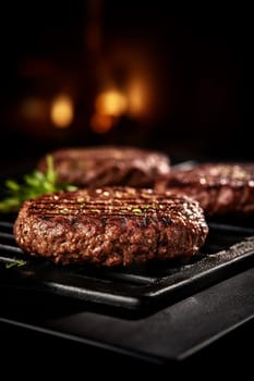 Juicy grilled burger patties on a cast iron pan, garnished with herbs.