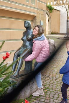 Winter Fun in Bitigheim-Bissingen: Beautiful Girl in Pink Jacket Amidst Half-Timbered Charm. Step into the festive winter spirit with this captivating image of a lovely girl in a pink winter jacket standing in the archway of the historic town of Bitigheim-Bissingen, Baden-Württemberg, Germany. The backdrop features charming half-timbered houses, enhanced by warm vintage photo processing, creating a delightful scene of winter joy and architectural beauty.