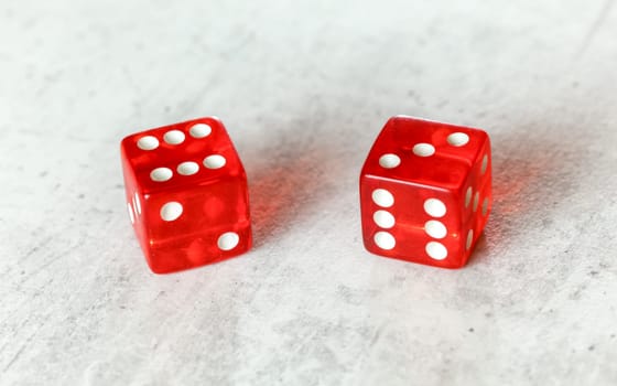 Two translucent red craps dices on white board showing Centerfield Nine / Nina (number 6 and 3)