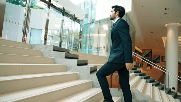 Professional business man going up the stairs. Successful man going up the stairs while explore a new thing. Represented traveling, getting a promotion, finding a new job, increasing skill. Exultant.