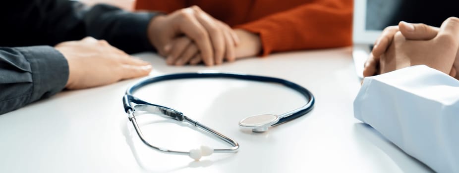 Couple attend fertility or medical consultation with gynecologist at hospital as family planning care for pregnancy. Husband and wife consoling each other through doctor appointment. Panorama Rigid