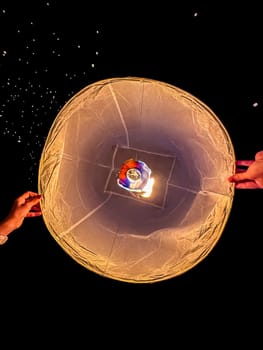 Sky lantern mass release event for Yee Peng and Loy Krathong festival in Chiang Mai, Thailand, south east asia