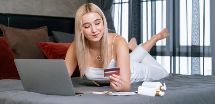 Young woman using laptop with credit card for internet banking, online shopping E commerce by online payment gateway at home office. Modern and convenience online purchase. Panorama Blithe