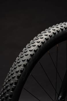 Close up photo of a bicycle against black background