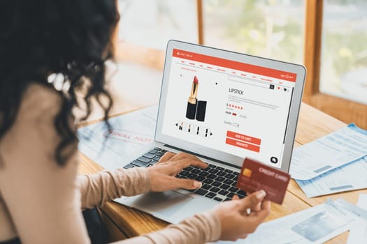 Woman shopping online on internet marketplace browsing for sale items for modern lifestyle and use credit card for online payment from wallet protected by crucial cyber security software