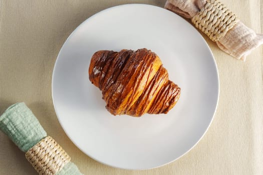 Flaky Croissant Rests Gracefully on a Minimalist White Plate, Creating a Serene Masterpiece.