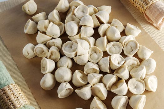 Freshly made, handcrafted dumplings and ravioli revealing the delicate folds and individual shapes of each piece.