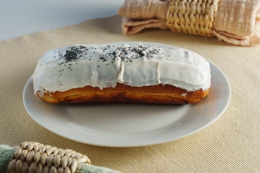 Donut with luscious frosting sits atop a pristine white plate, showcasing the perfect balance of flavors.