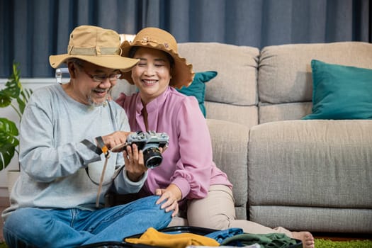 Travel and tourism. Happy mature retired couple photography weekend holiday, Asian couple old senior marry retired couple smiling taking photo by camera during luggage suitcase arranging for travel