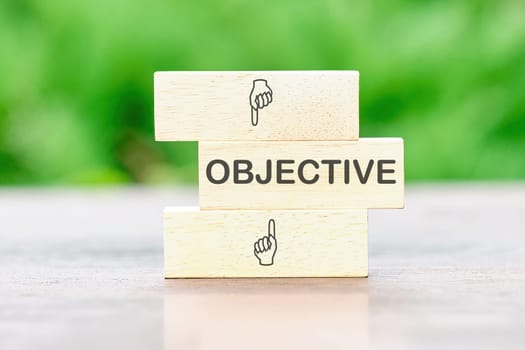 OBJECTIVE Back to school the inscription on wooden bars against a background of green plants is out of focus