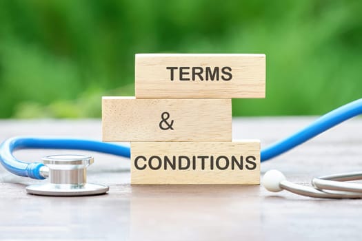 TERMS AND CONDITIONS text on wooden blocks on a green background