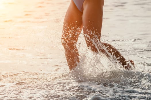 Running woman. Female runner jogging during the sunrise on beach. Woman Runner feet running on the beach at sunrise. woman fitness sunrise jog workout wellness concept.