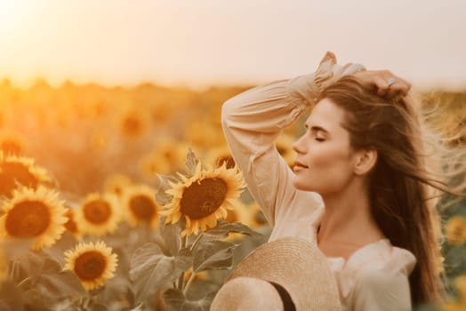 Woman in the sunflowers field. Summer time. Young beautiful woman standing in sunflower field.