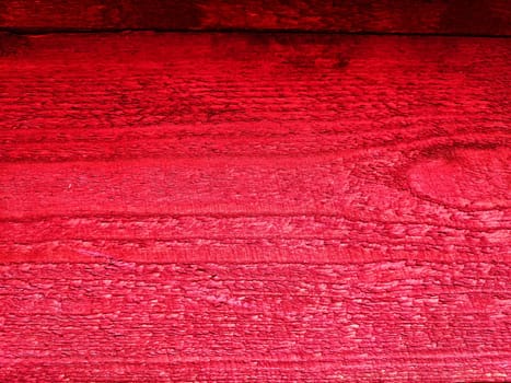 Abstract background with old wooden boards painted with red paint with texture and knots. Pattern, place for text, copy space