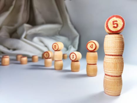 Small wooden barrels with numbers built in columns. The concept of duration and ways to achieve the goal. The sequence of actions to obtain the effect and result