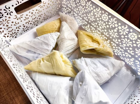 Plastic bag folded into triangle for storage. Ways of storing and laying at home