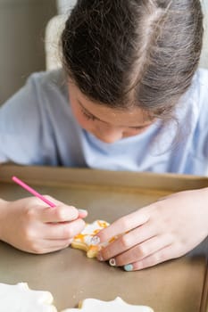 A heartwarming scene of a little girl carefully writing 'Sorry' on sugar cookies with food coloring, the cookies beautifully flooded with white royal icing.