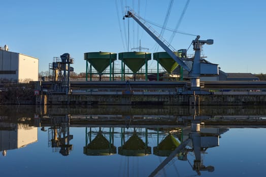 Riverside Manufacturing Hub. Eco-Friendly Technology and Production. Explore the synergy of technology and production at the Riverside Manufacturing Hub, nestled by the river. Witness the balance between industry and the environment, showcasing the integration of sustainable practices. This image captures the essence of eco-friendly manufacturing and its harmonious coexistence with the surrounding natural beauty.